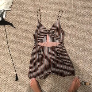 Pink, black, and white striped romper with cut out